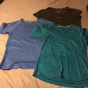 Three medium Nike running dri-ft shirts.
